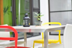a table with a candle and a potted plant on it at Tainan Anping - Shuiau 180 in Tainan