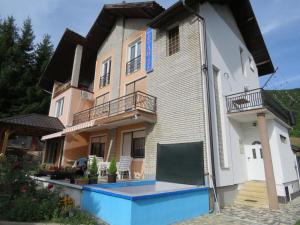 a building with a swimming pool in front of it at Villa Artemida in Kulen Vakuf