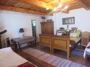 a bedroom with a desk and a bed and a table at Molnárporta in Szentgyörgyvölgy