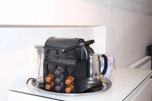 a coffee maker on top of a counter with donuts at Koningshof in Alkmaar +10 photos