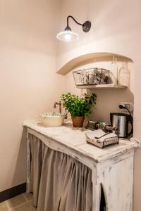 a kitchen counter with a sink and plants on it at Borgo San Gaetano in Bernalda