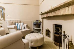 a living room with a chair and a fireplace at Borgo San Gaetano in Bernalda