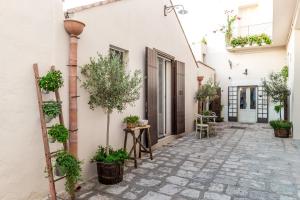 a courtyard with potted plants on the side of a building at Borgo San Gaetano in Bernalda