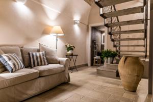a living room with a couch and a staircase at Borgo San Gaetano in Bernalda