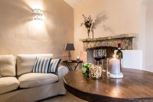a living room with a couch and a table with wine glasses at Borgo San Gaetano in Bernalda