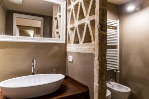 a bathroom with a tub and a sink and a mirror at Borgo San Gaetano in Bernalda