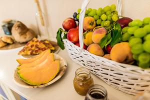 a table with a basket of fruit on it at Borgo San Gaetano in Bernalda