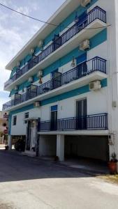 a large building with balconies on the side of it at To Giouli in Volos