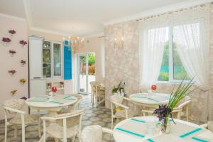 a dining room with two tables and chairs at Mini Hotel Ryleev in Kharkiv