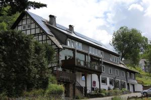 a large white house with a gambrel roof at Pension Droste- Vogt in Schmallenberg