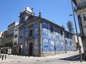 a building covered in blue and white tiles on a street at Sendme2Portugal: Santa Catarina in Porto