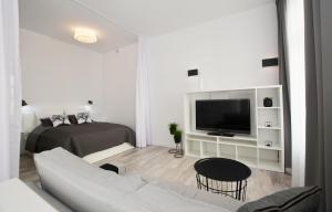 uma sala de estar com um sofá e uma televisão em Apartament Towarowa Kolobrzeg em Kolobrzeg