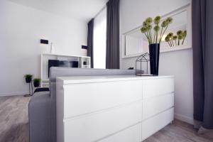 biała komoda w salonie z kanapą w obiekcie Apartament Towarowa Kolobrzeg w Kołobrzegu