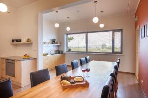 a kitchen and dining room with a table and chairs at Harbor House Lõmala in Lõmala