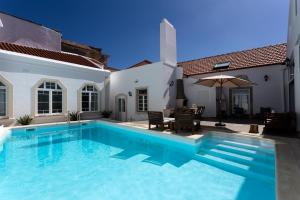 a swimming pool in the backyard of a house at Ericeira Soul Guesthouse in Ericeira