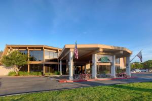 a building with an american flag in front of it at Red Lion Hotel Redding in Redding