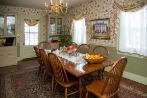 a dining room with a table with a bowl of fruit on it at Daniel Stebbins B and B in South Hadley