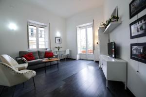 a living room with a couch and a tv at Amazing Politeama House in Palermo