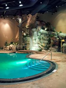 a swimming pool with a waterfall and a rock wall at Tulalip Resort Casino in Marysville