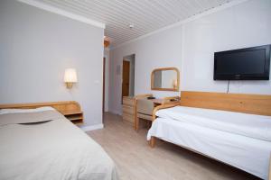 Postel nebo postele na pokoji v ubytování Stetind Hotel