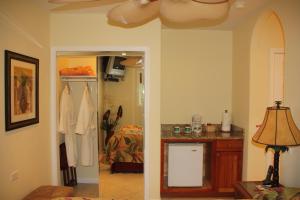 a room with a kitchen and a room with a table at Maui Beach House B & B in Kahana +26 photos