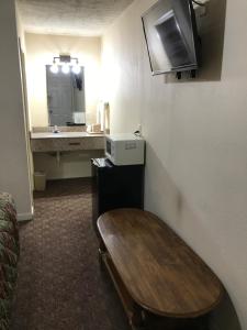 a room with a table and a sink in a room at Travelers Inn Motel in Fulton +8 photos