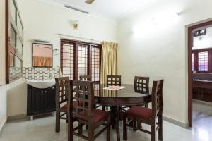a dining room with a table and chairs and a sink at Stay at DBRA 61 Don Bosco Cross Road Vaduthala Ernakulam in Cochin +11 photos