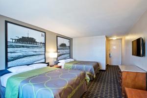 a hotel room with two beds and a flat screen tv at The Hotel 39 in Westminster