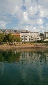 a body of water with buildings in the background at FAFALIOS Studios in Vrontádos