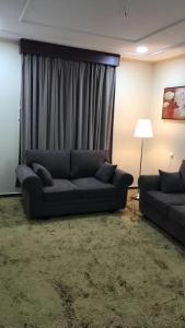 a living room with a couch in front of a window at منازل الساهر للوحدات السكنية فرع 1 in Al Qunfudhah