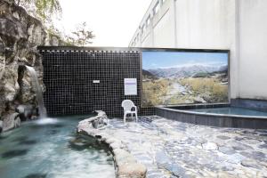 a hot tub with a tv on the side of a building at The K Jirisan Family Hotel in Gurye