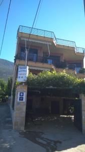 a building with a sign in front of it at Nikolitsa Apartments in Glyfada Fokidas