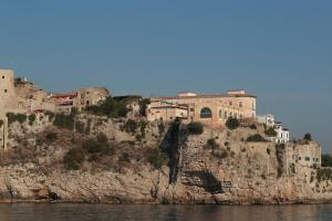 a building on a cliff next to the water at Sunrise Guest House in Gaeta