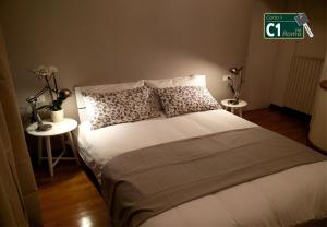 a bedroom with a large bed with two tables at Carlo's B149C - Sanremo Center Suite - da Carlo - in Sanremo