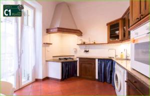 a kitchen with a sink and a stove top oven at Carlo's B149C - Sanremo Center Suite - da Carlo - in Sanremo