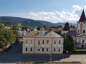 an old building in the middle of a town at Ultracentral Bucovina in Gura Humorului