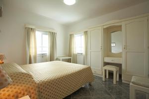 Residence Capri tesisinde bir odada yatak veya yataklar