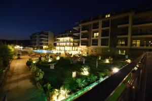 a building with a garden at night with lights at Hierapark Thermal & SPA Hotel in Pamukkale