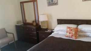 Postel nebo postele na pokoji v ubytování Midtown Guest House