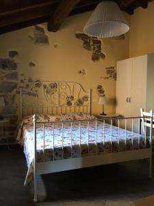 Un pat sau paturi într-o cameră la Alloggio del Grand Tour