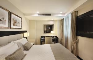 a hotel room with a bed and a desk at Miramar By Windsor Copacabana in Rio de Janeiro