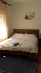 a bedroom with a large bed with a blanket at Vacation Home Katarina in Čapljina