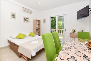 a bedroom with a bed and a table and chairs at Apartments Mustapic in Makarska