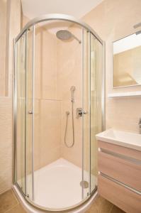 a shower with a glass enclosure in a bathroom at Apartments Mustapic in Makarska +78 photos