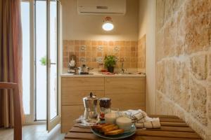 a kitchen with a table with food on it at HolidayMonopoli in Monopoli