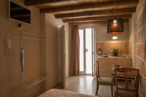 a kitchen and dining room with a table and a window at HolidayMonopoli in Monopoli