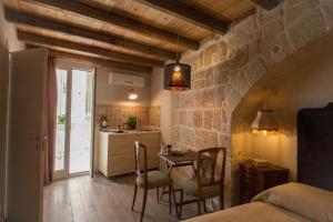 a kitchen and dining room with a table and chairs at HolidayMonopoli in Monopoli