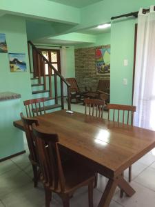 a dining room with a wooden table and chairs at Club house in Prainha