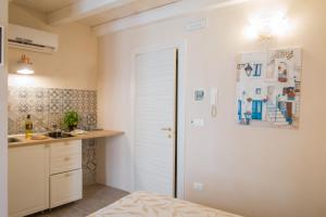 a kitchen with a white door and a counter at HolidayMonopoli in Monopoli