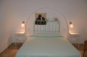 ein Schlafzimmer mit einem Bett und zwei Nachttischen in der Unterkunft Trulli Casa Alberobello in Alberobello